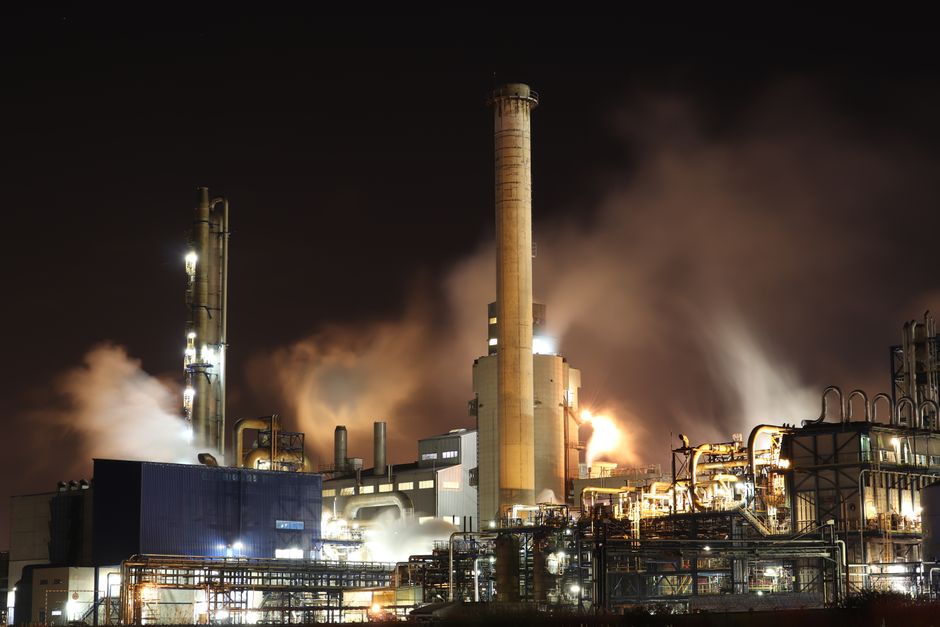 한국 금융시장 동향 — 2026년 9월 2일(수) — A nighttime view of an industrial factory with smokestacks emitting smoke, highlighting energy production and pollution.